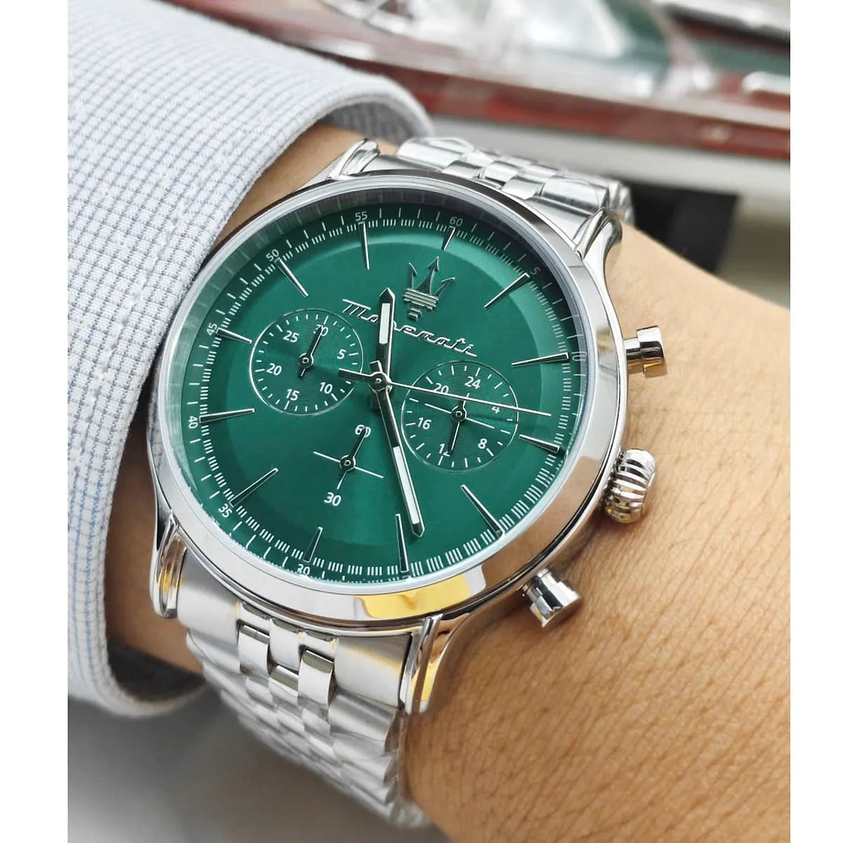 Maserati Epoca men's chronograph on wrist showing green sunray dial and steel case