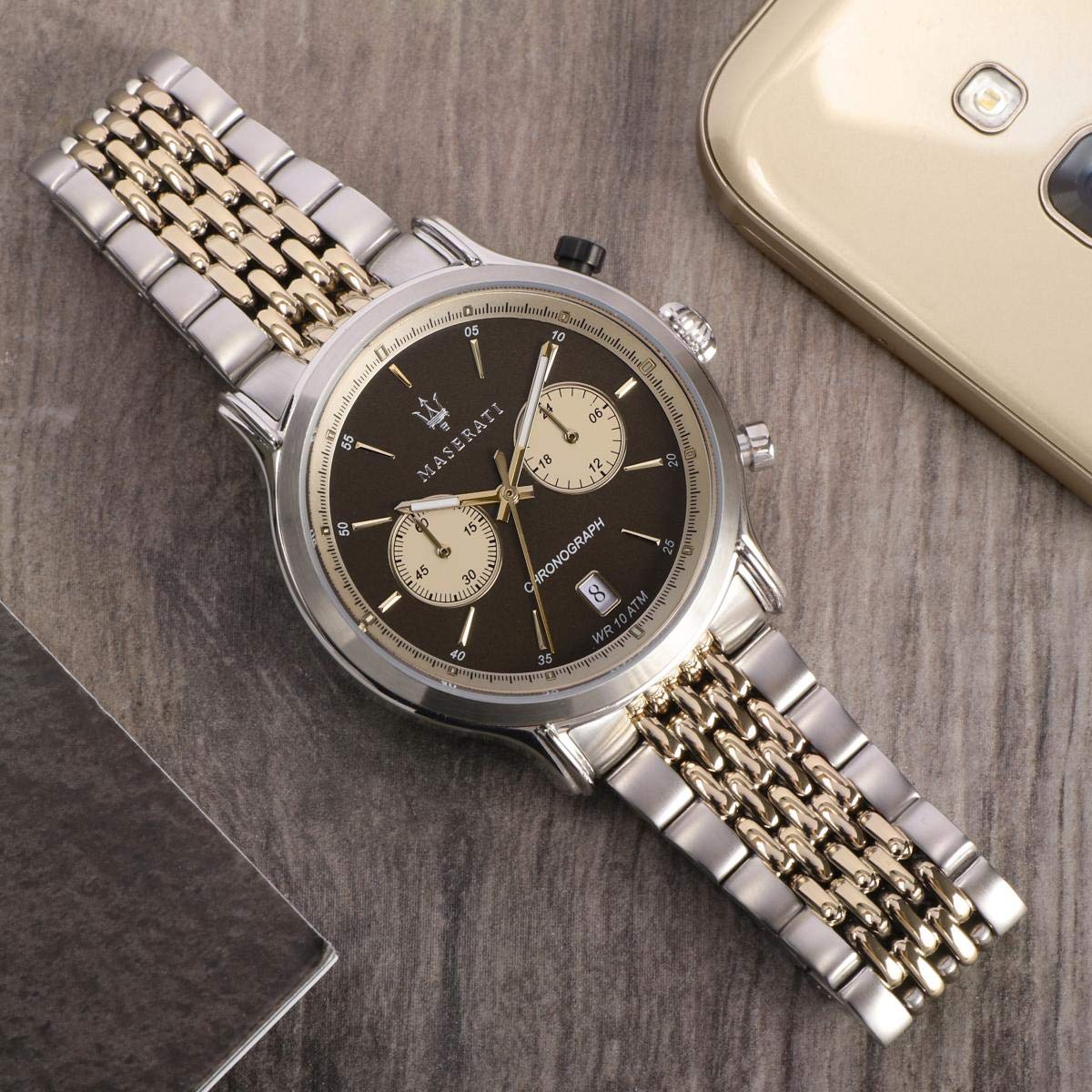 Maserati chronograph watch on wrist showing brown dial and two-tone metal bracelet