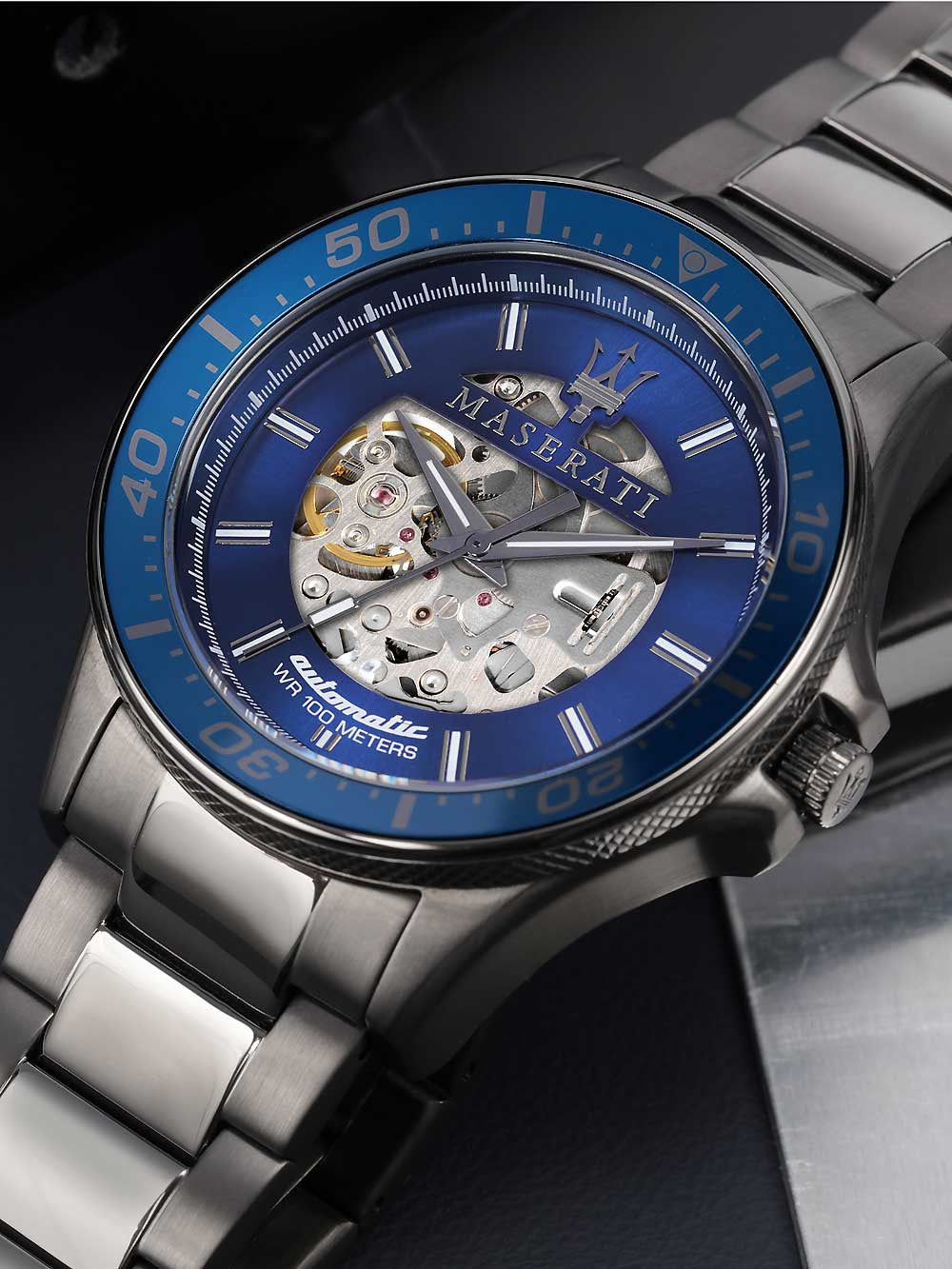 Maserati Sfida dial detail view showing skeleton movement, blue face, Roman numerals, and steel hands