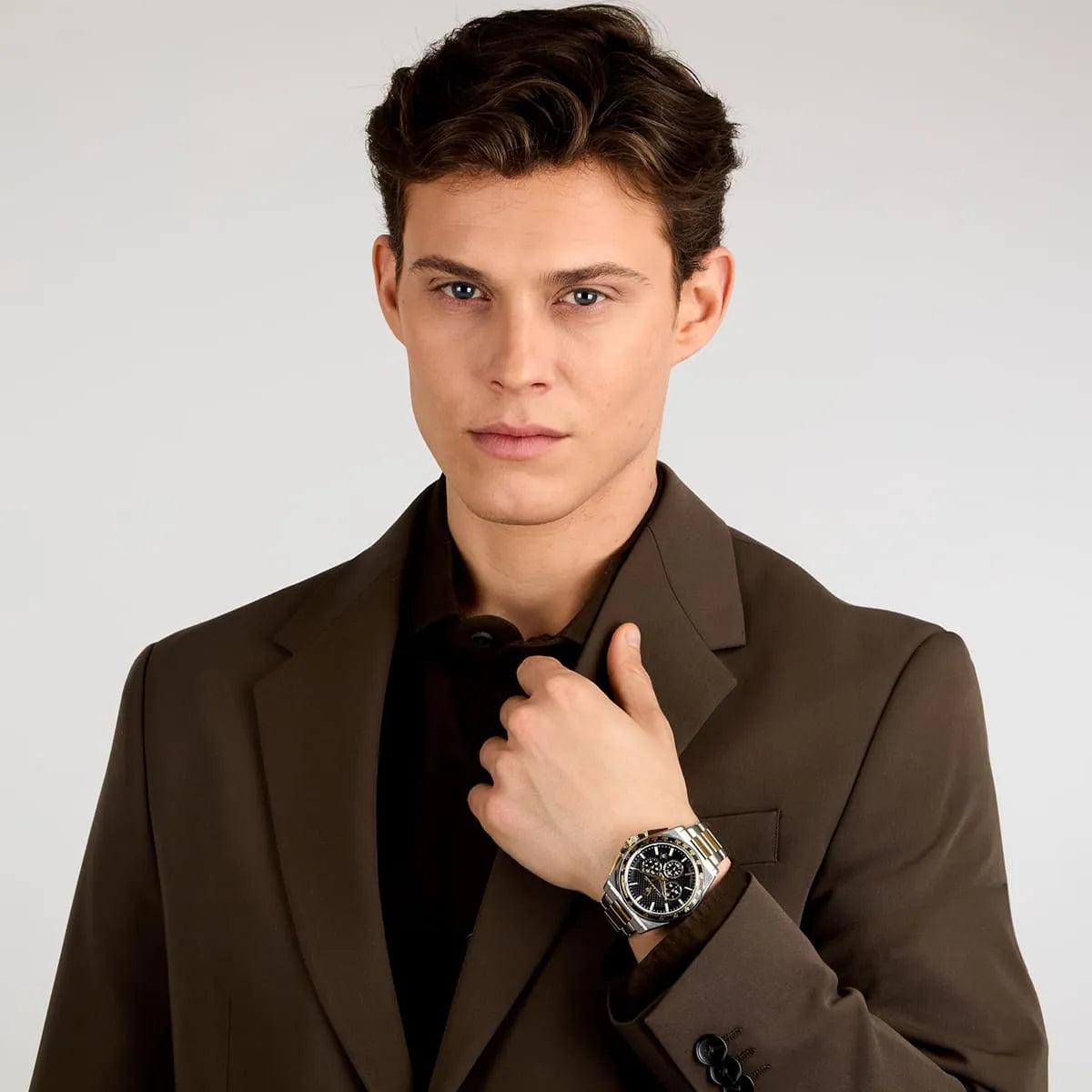 Man wearing Maserati Velocità R8873652003 two-tone chronograph watch with black dial