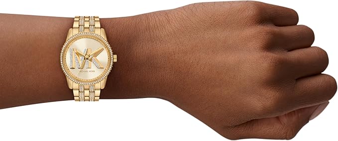 Michael Kors Bryant MK7540 gold watch worn on wrist with crystal-set case and bracelet