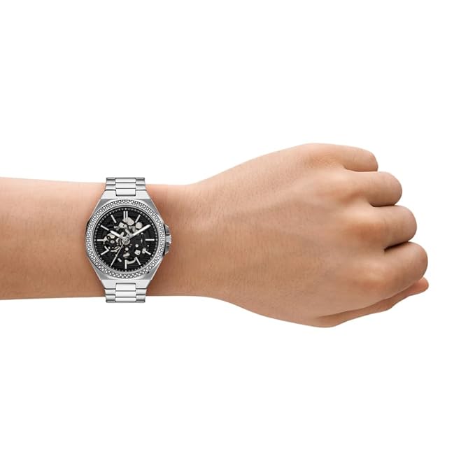 Michael Kors Callum automatic watch worn on wrist with stainless steel bracelet