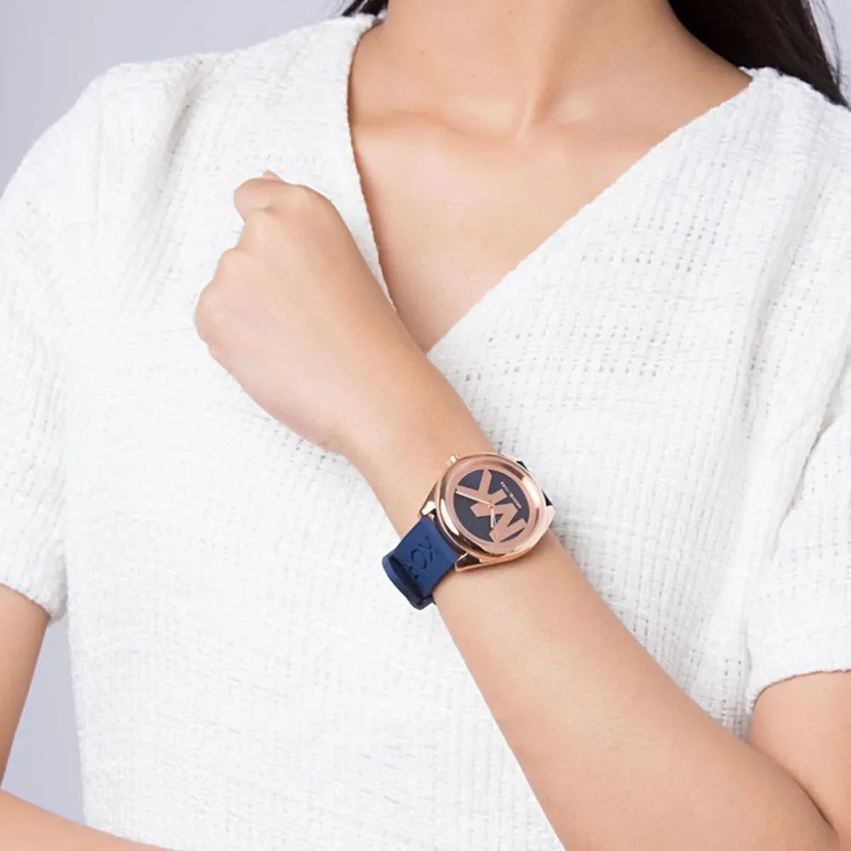 Michael Kors Janelle watch worn on wrist showing blue dial and blue rubber strap