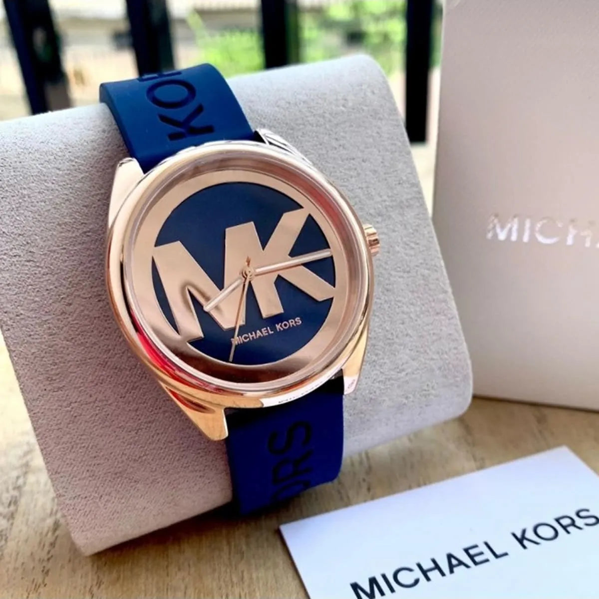 Michael Kors Janelle watch on wrist with box packaging visible in background