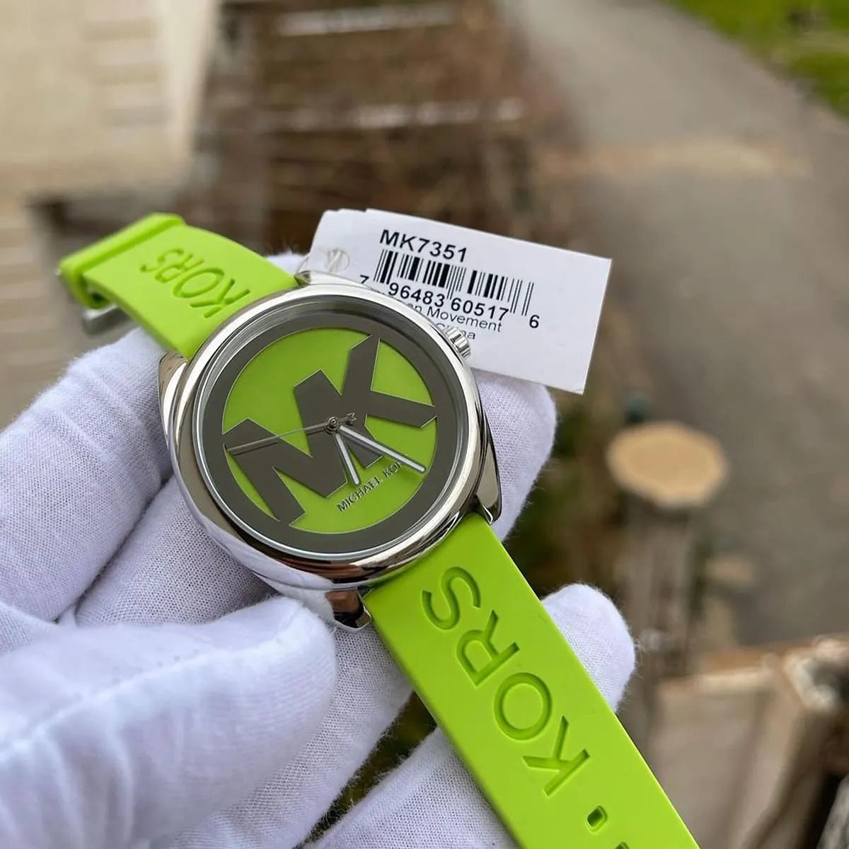 Michael Kors Janelle watch on hand displaying neon green dial with MK logo