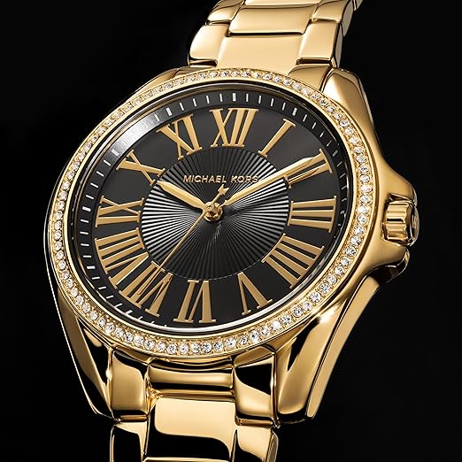 Michael Kors Kacie watch angled view featuring gold steel case, black dial, and crystal bezel