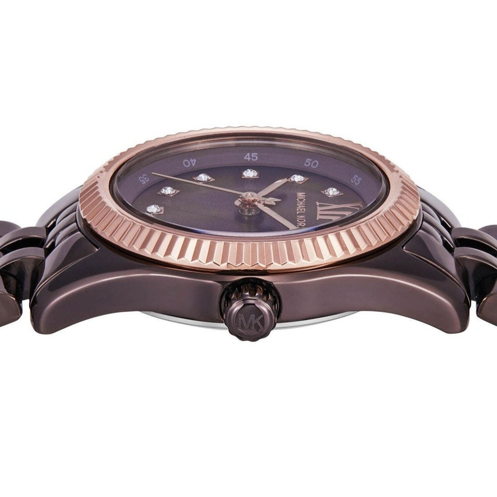 Close-up dial detail with crystal pavé markers and rose-gold bezel on espresso face
