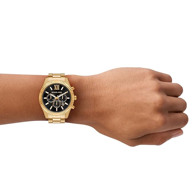 Michael Kors Lexington gold chronograph watch worn on wrist with black dial
