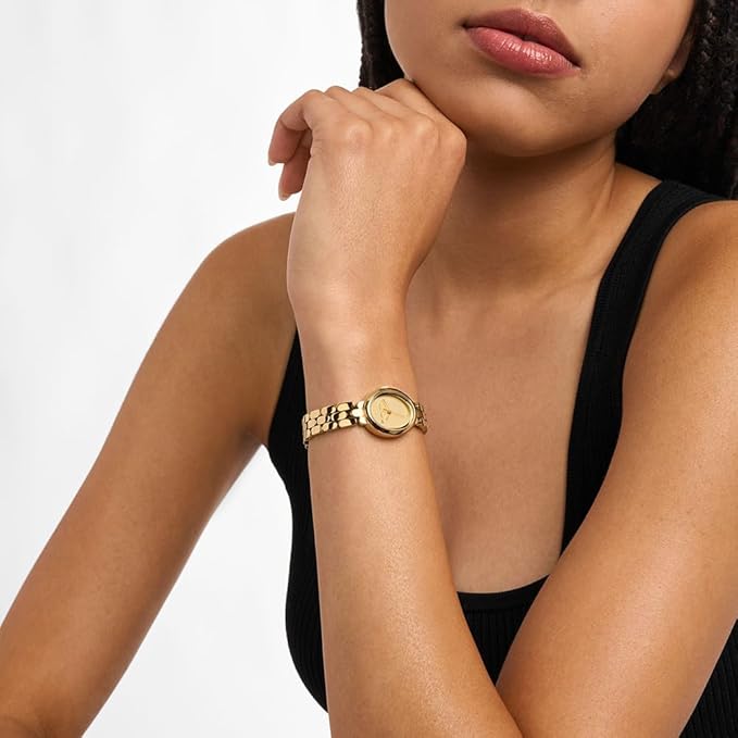 Michael Kors Maude gold watch on wrist showing oval dial and link bracelet