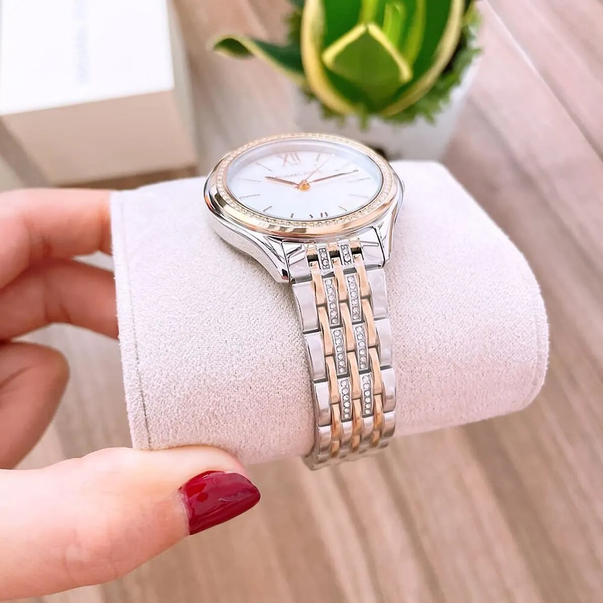 Michael Kors Mindy MK7084 watch displayed on pink cushion with packaging visible