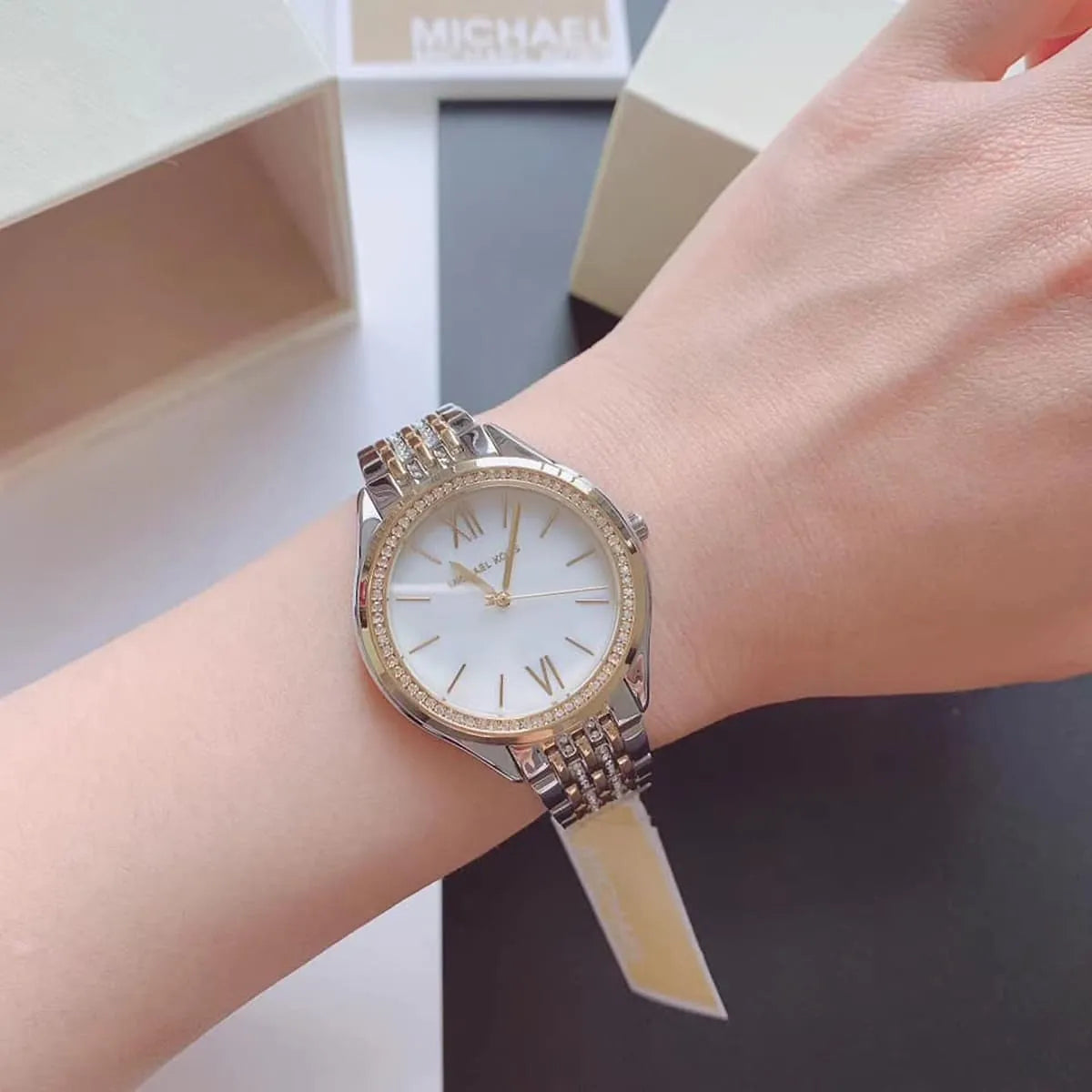 Michael Kors Mindy MK7084 worn on wrist showing white dial and crystal bezel