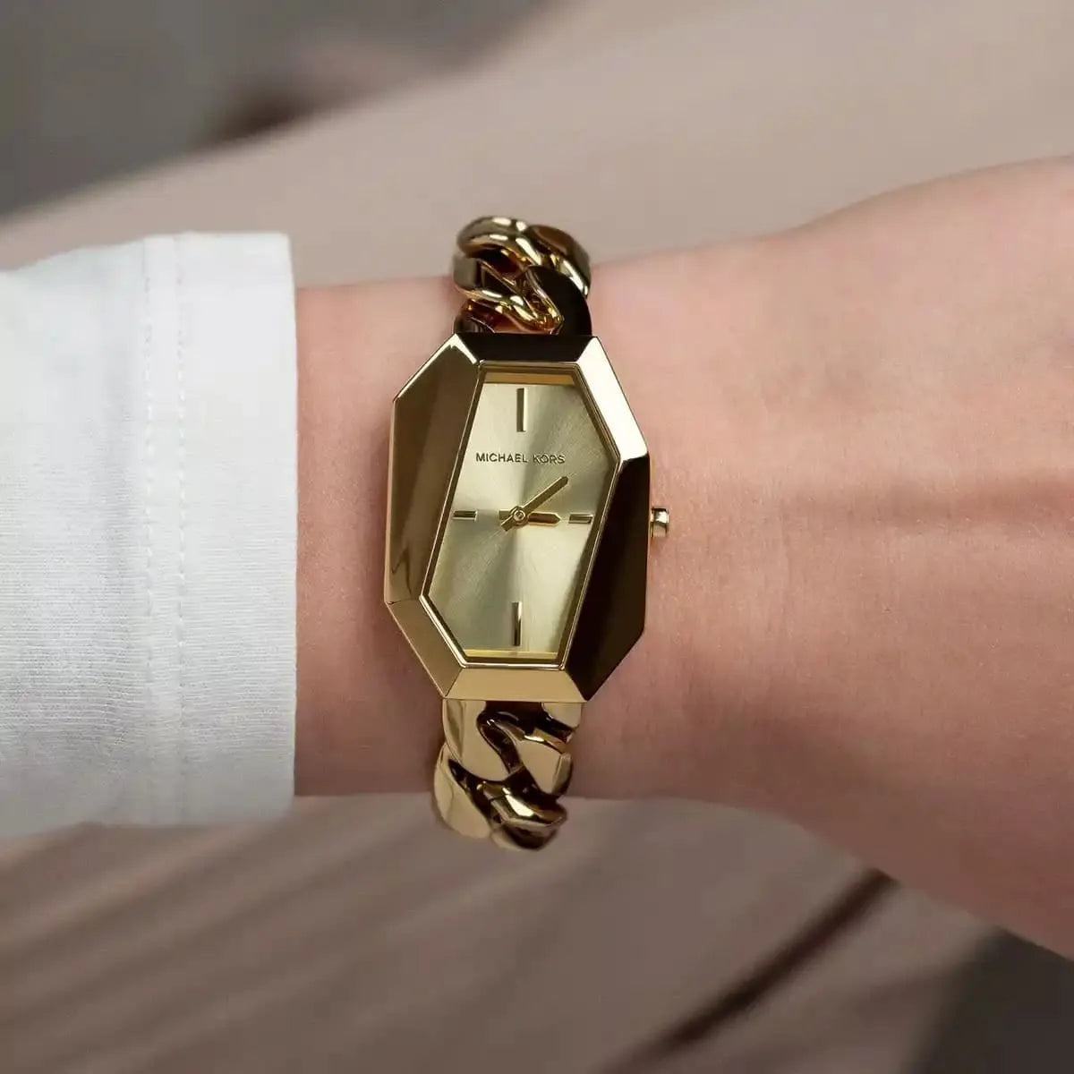 Michael Kors Mini Suri gold-tone watch worn on wrist with cream dial visible