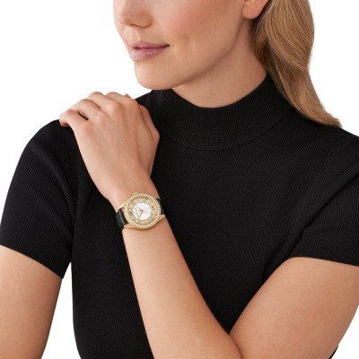 Michael Kors MK2988 Harlowe watch worn on wrist with gold case and black strap