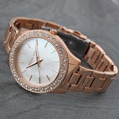 Michael Kors MK4557 Liliane rose gold watch worn on wrist with crystal bezel