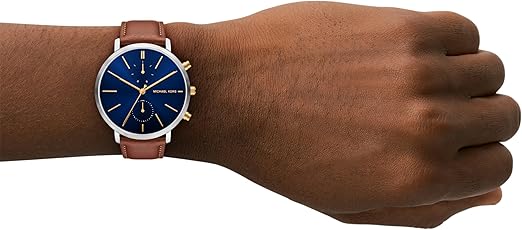 Michael Kors MK9209 chronograph watch worn on wrist with navy dial and brown leather strap