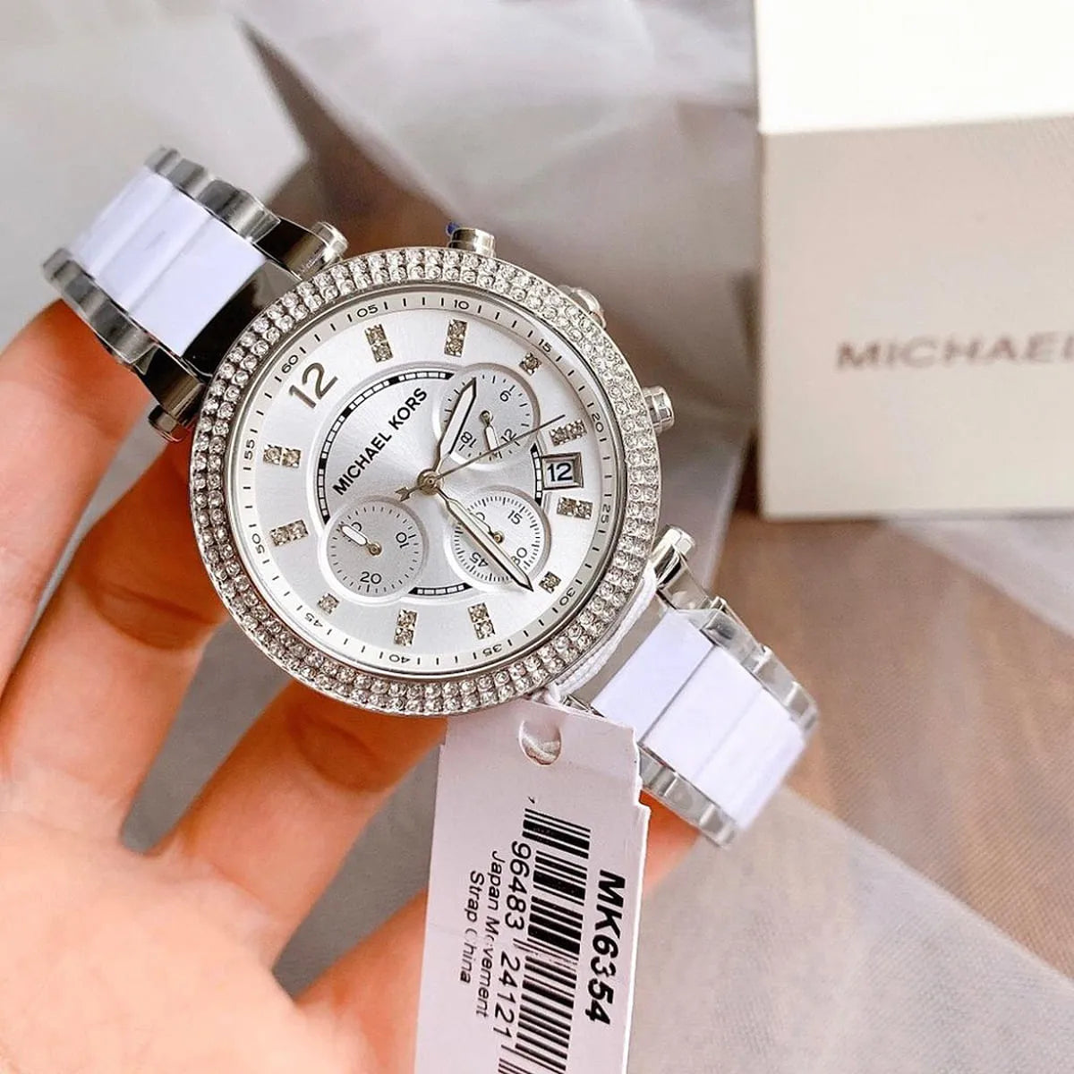 Parker MK6354 chronograph watch on wrist showing silver dial and white metal-ceramic bracelet