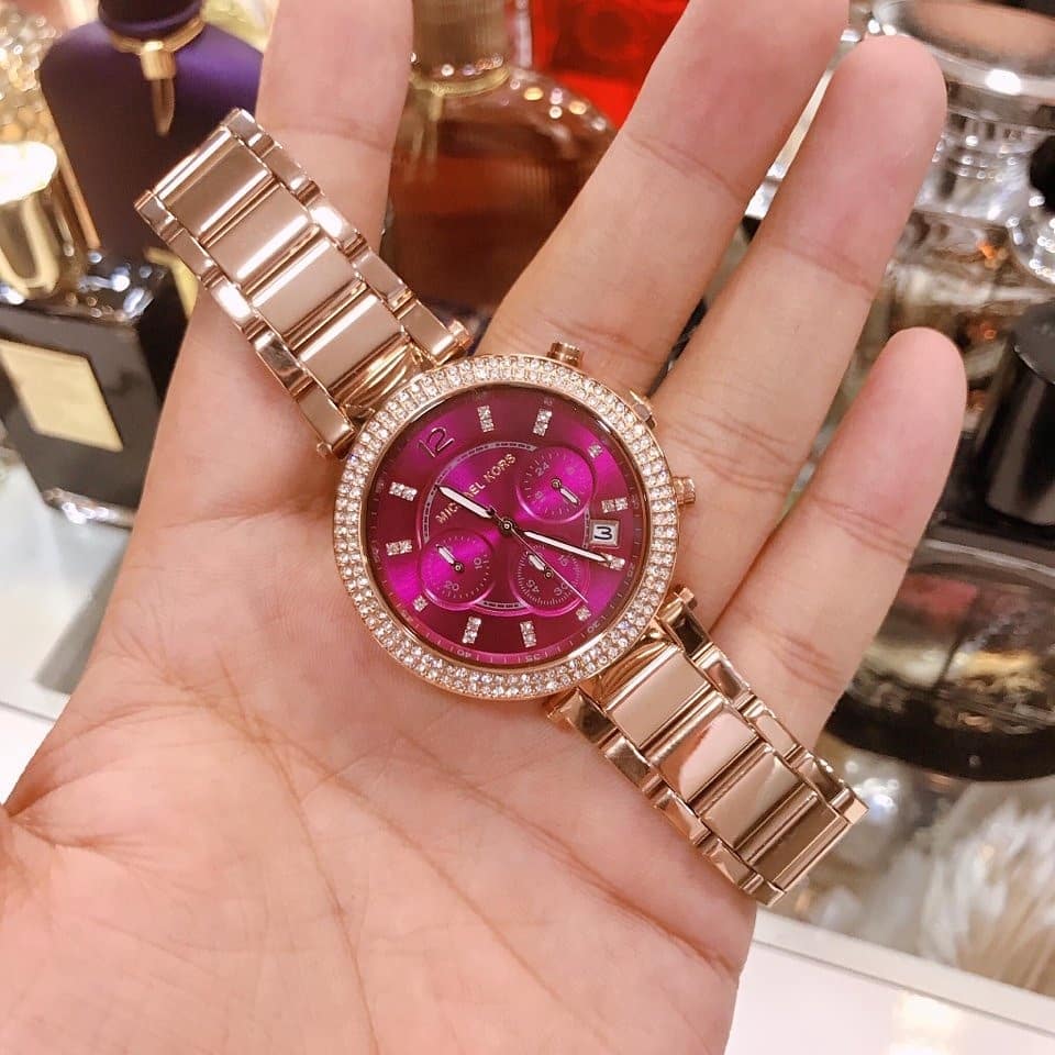 Michael Kors Parker plum dial watch worn on wrist showing rose gold case and bracelet