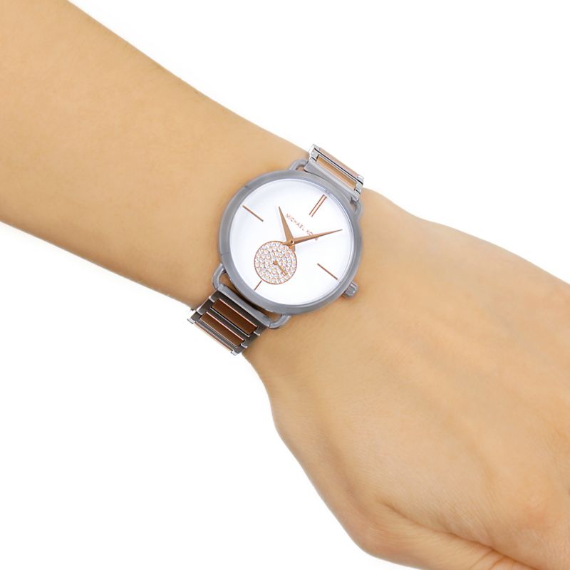 Michael Kors Portia watch worn on wrist showing silver dial and two-tone bracelet fit