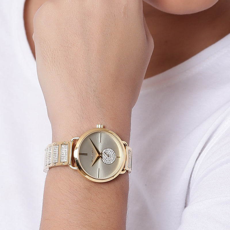 Michael Kors Portia gold-tone watch on wrist showing full view and bracelet fit