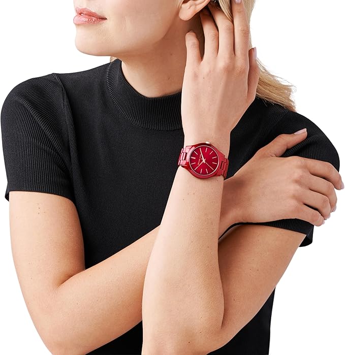 Michael Kors red watch worn on woman's wrist with minimalist dial design
