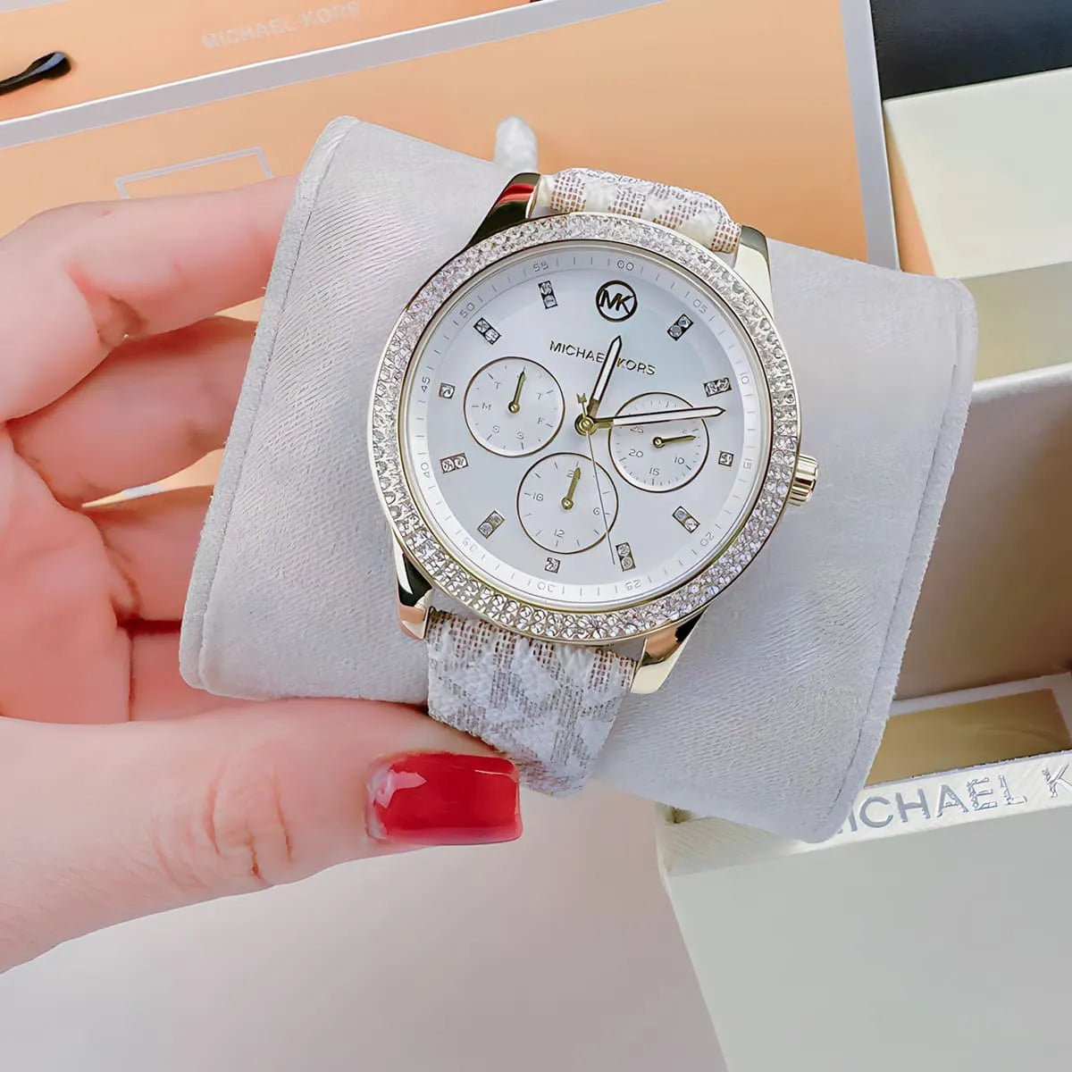 Michael Kors Tibby watch being held in hand with packaging visible