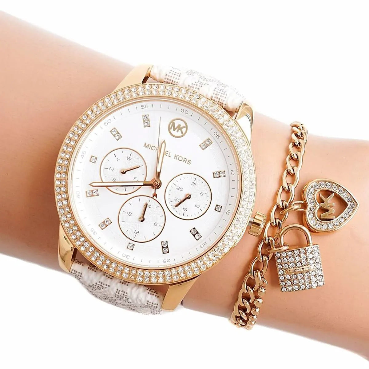 Michael Kors Tibby watch on wrist with gold bracelet charm accessory