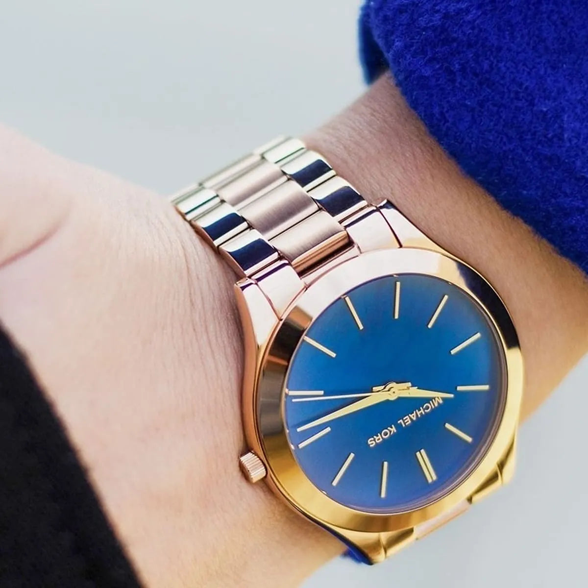 Michael Kors Slim Runway MK3494 on wrist with blue dial and rose gold bracelet strap