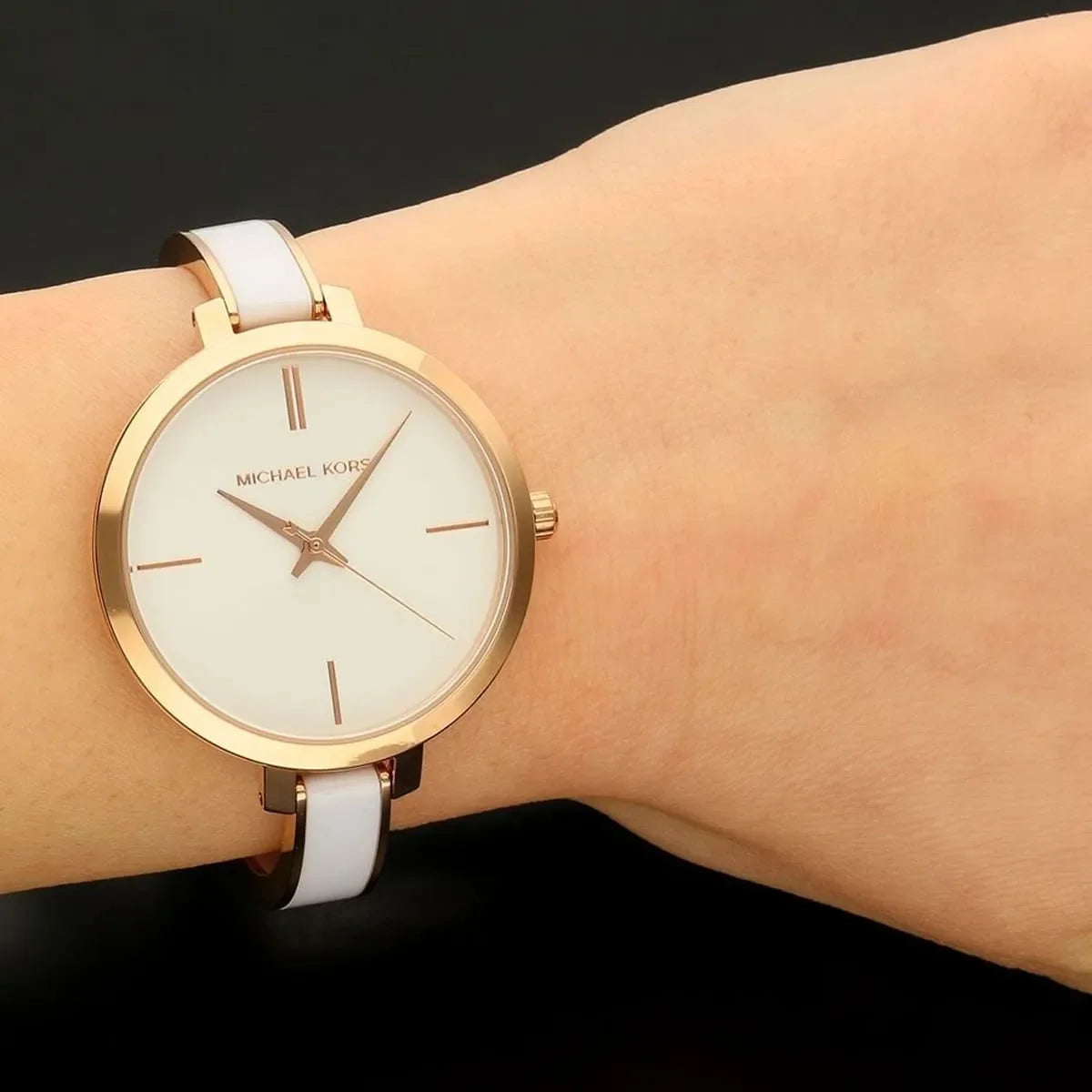 Michael Kors Jaryn women's watch worn on wrist showing white dial and rose gold case