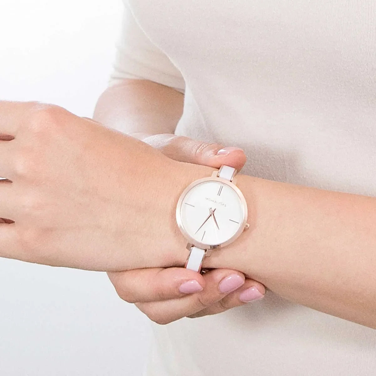 Michael Kors Jaryn analog watch on wrist with white dial and white acrylic strap