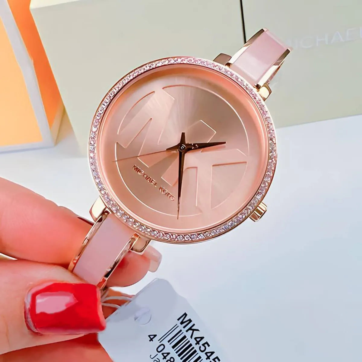 Michael Kors Jaryn watch worn on wrist with rose gold dial and pink leather strap