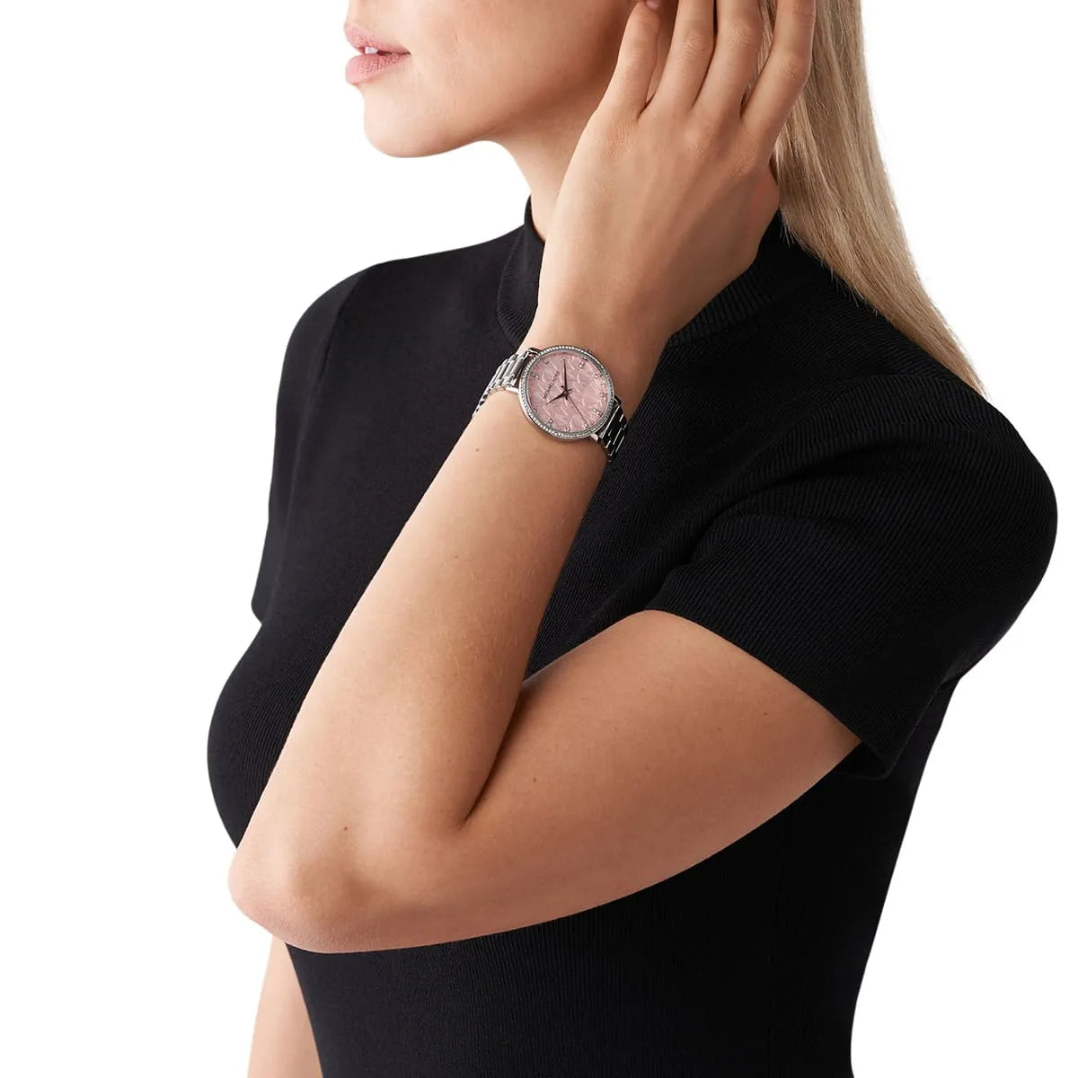 Michael Kors Pyper watch worn on wrist showing pink dial with silver bracelet and bezel