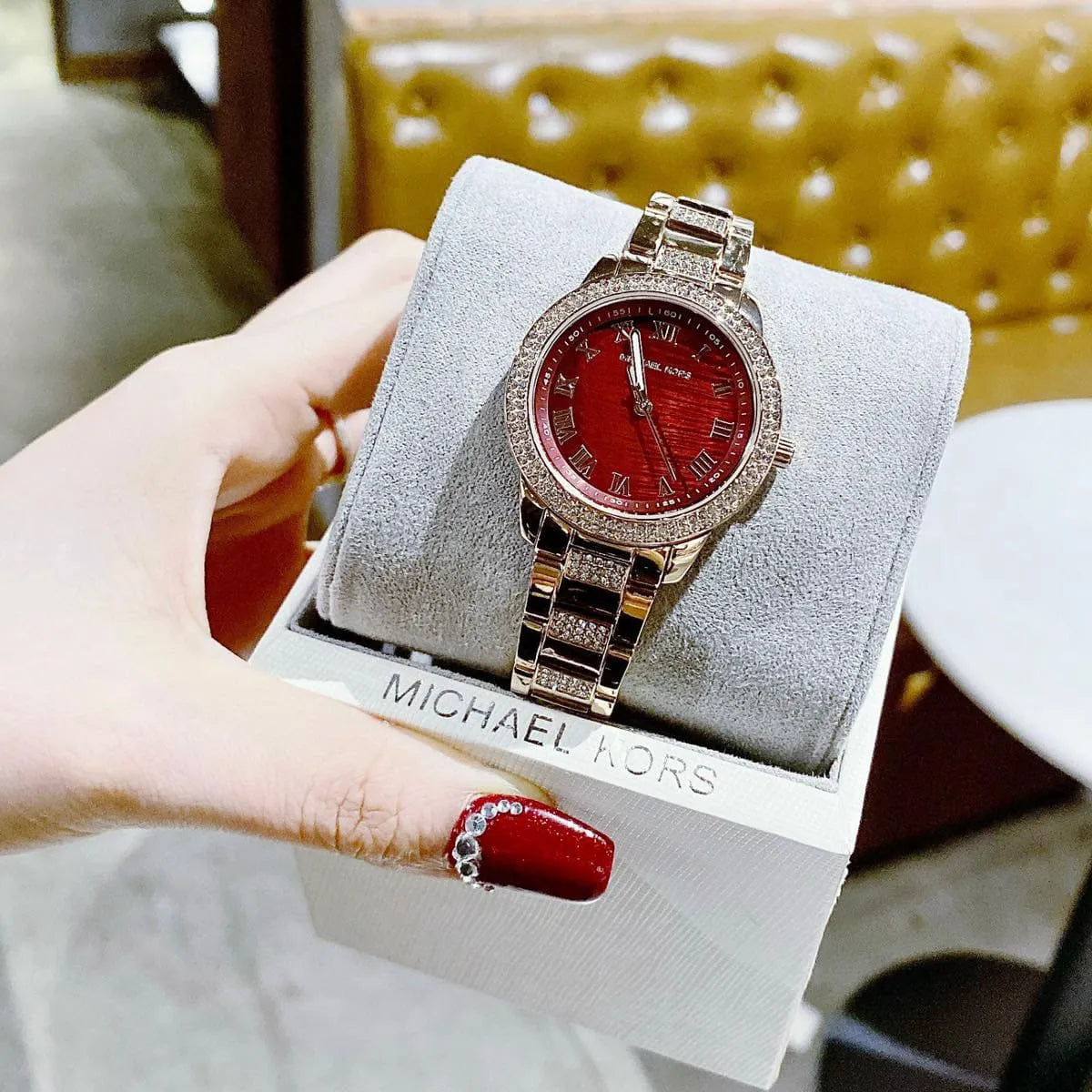 Michael Kors Tibby watch worn on hand displaying crystal-set case and rose gold bracelet
