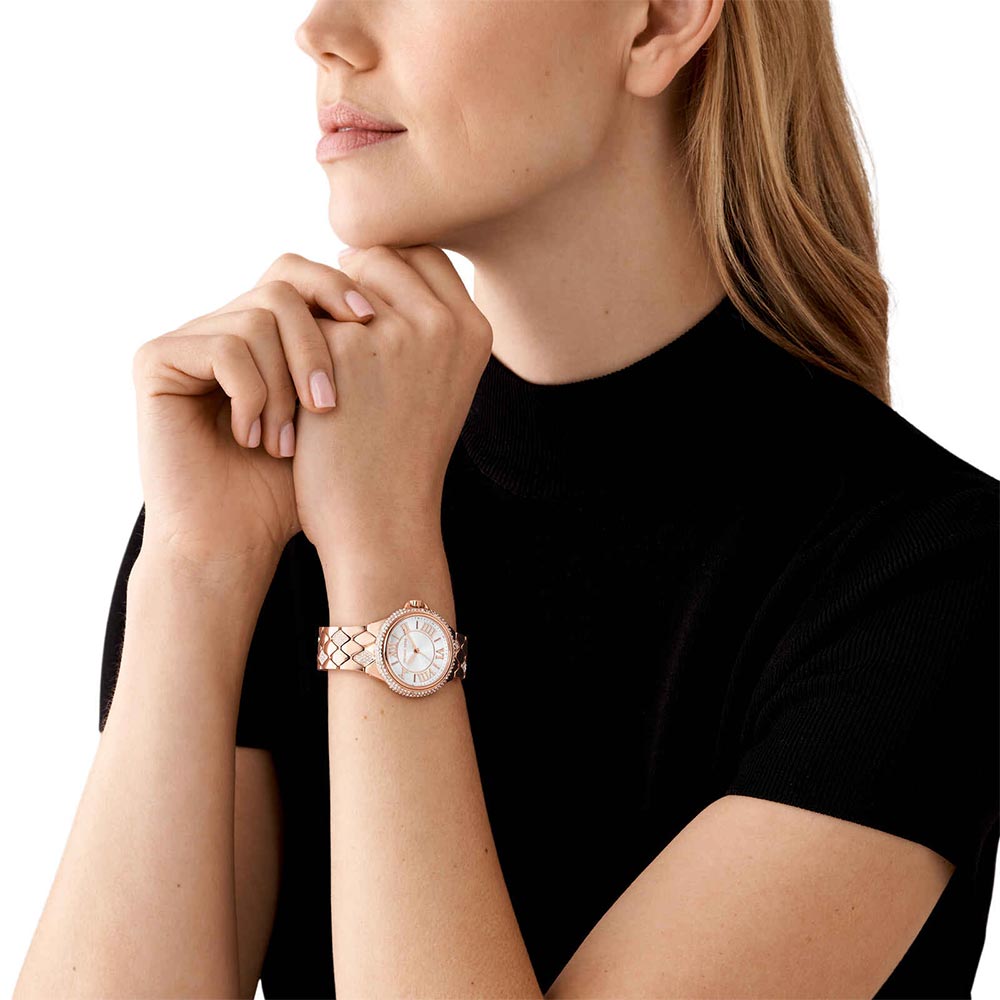 Michael Kors Camille rose gold watch worn on wrist with quilted bracelet strap