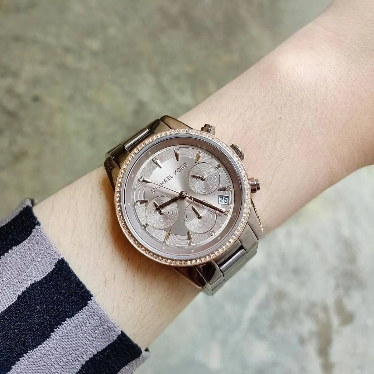 Michael Kors Ritz chronograph watch worn on wrist with stainless steel bracelet