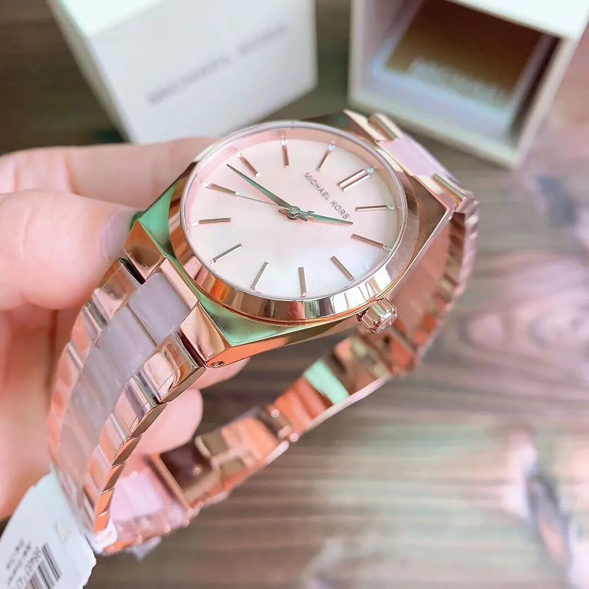 Michael Kors Channing watch detail view showing white dial and rose gold accents