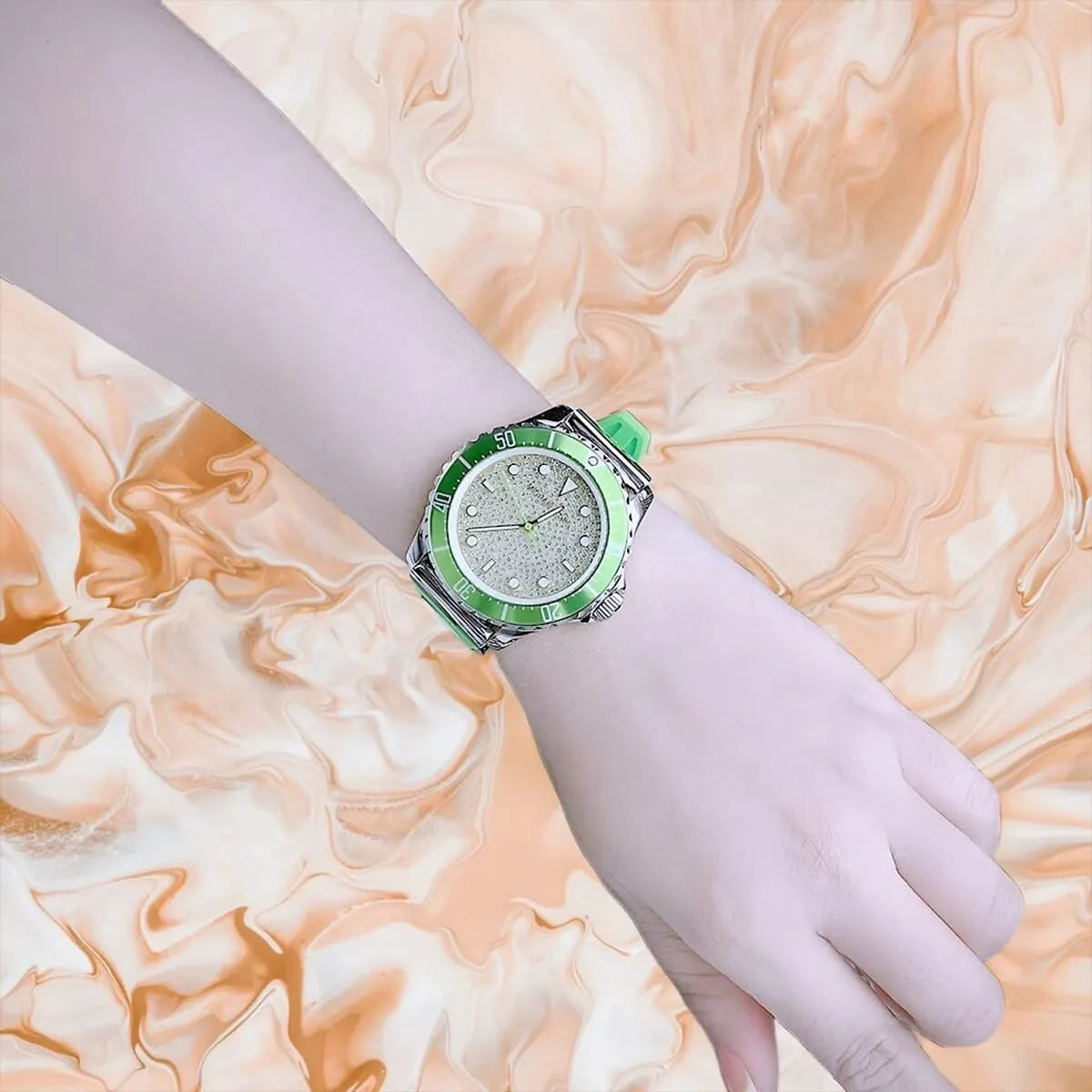 Michael Kors Everest watch on wrist with angled view of green bezel and crystal dial
