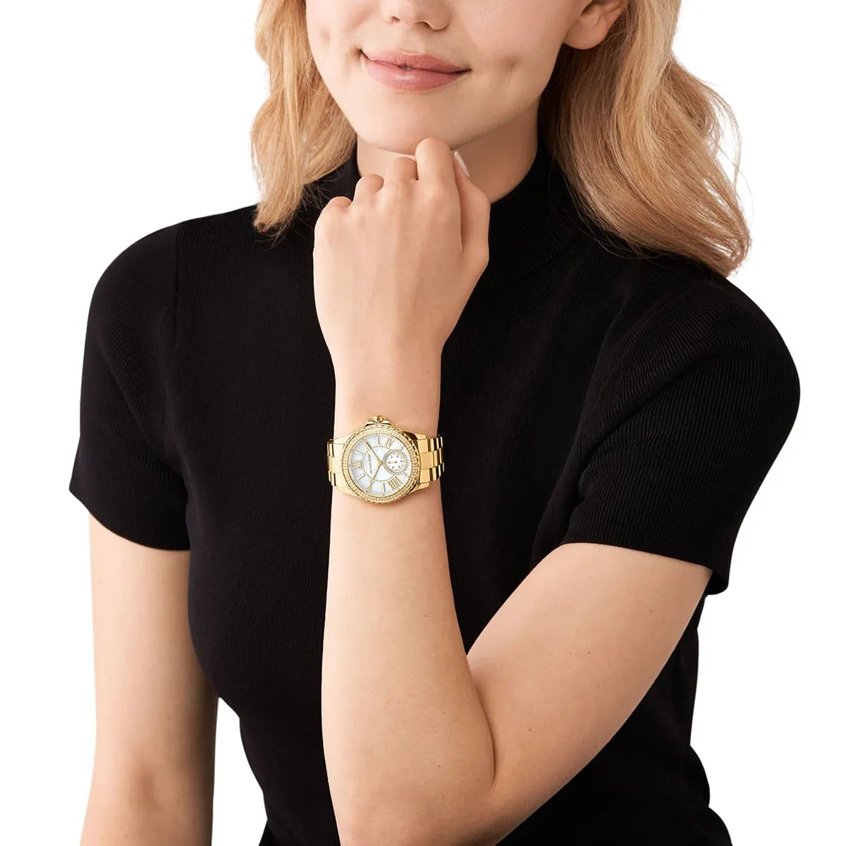 Michael Kors Everest women's watch worn on wrist with mother-of-pearl dial and gold-tone band