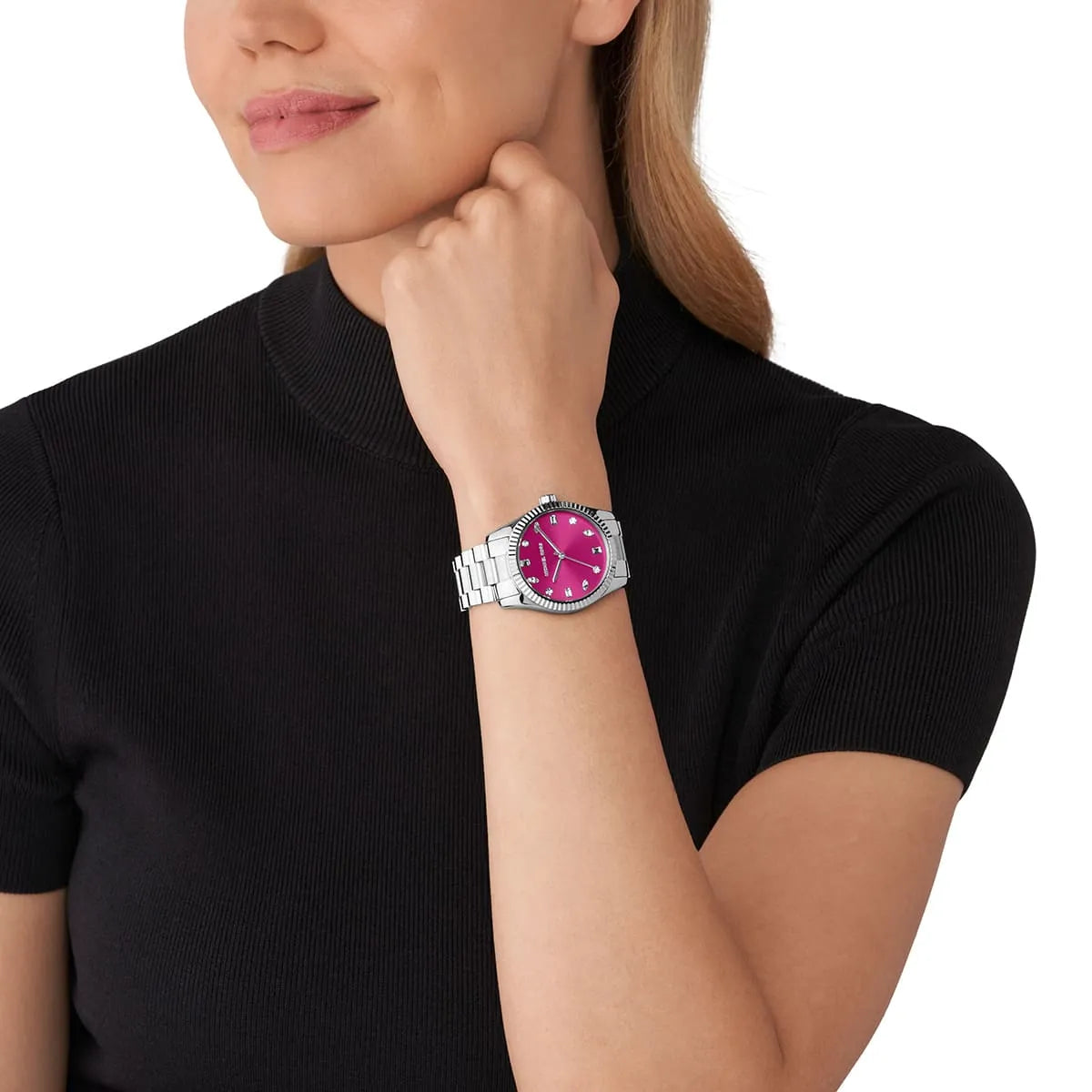 Michael Kors Lexington MK7443 watch worn on wrist showing pink dial with silver bracelet