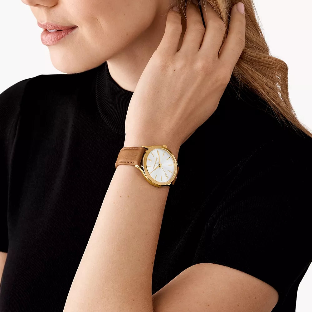 Michael Kors Slim Runway watch worn on wrist, showing white dial and brown leather strap