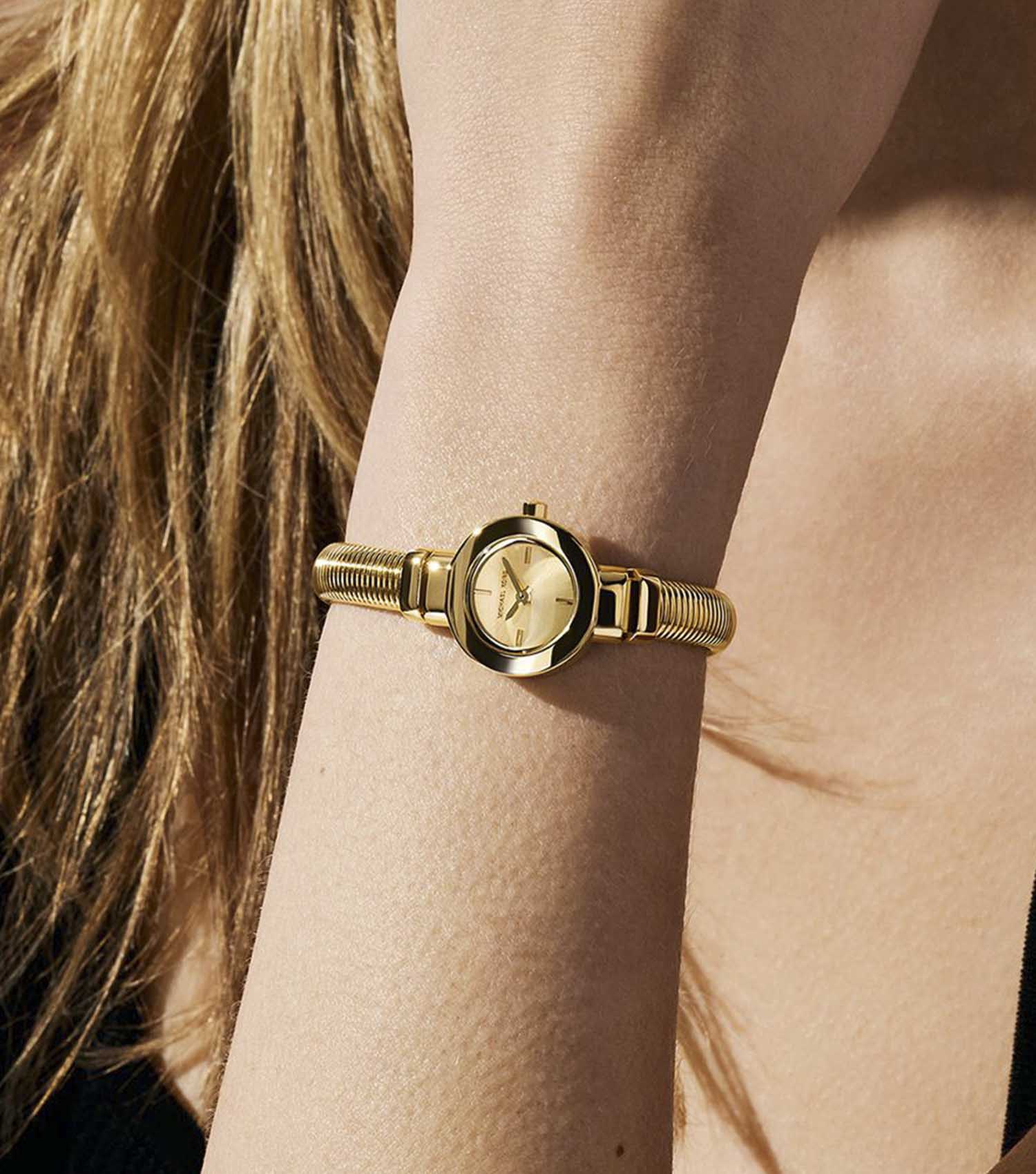 Michael Kors Mini Gramercy MK7527 gold-tone watch worn on wrist with textured strap