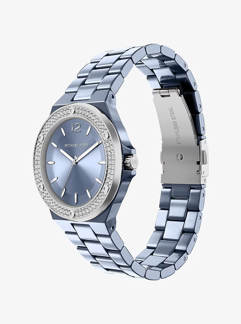 Michael Kors Mini Lennox watch worn showing blue dial with pavé bezel and steel bracelet
