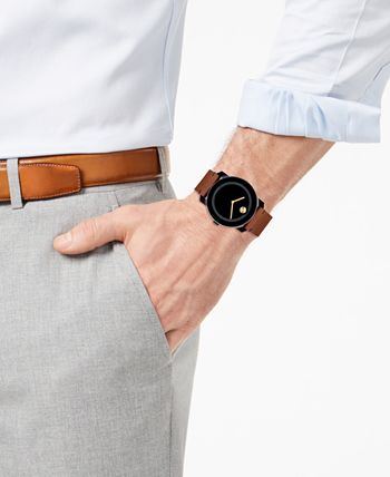 Movado Bold watch worn on wrist with black dial and brown leather strap