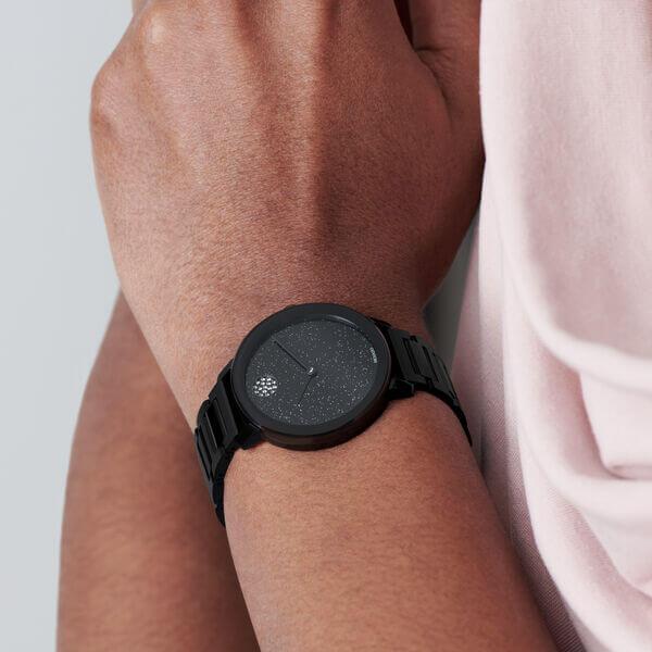 Movado Bold black steel women's watch worn on wrist with crystal dial and black strap