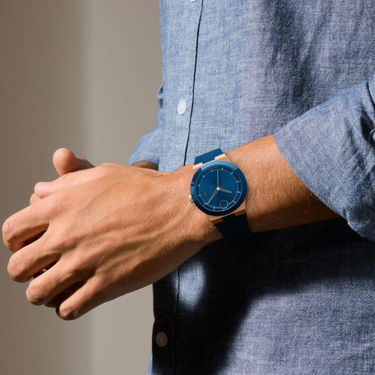 Movado BOLD Fusion blue watch worn on wrist with blue dial and black rubber strap