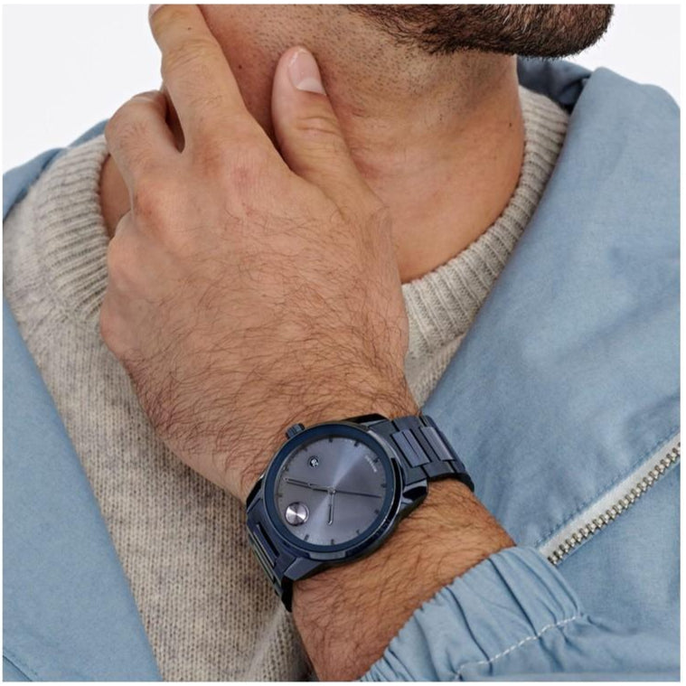 Movado Bold Verso blue watch worn on wrist showing dial and metal band