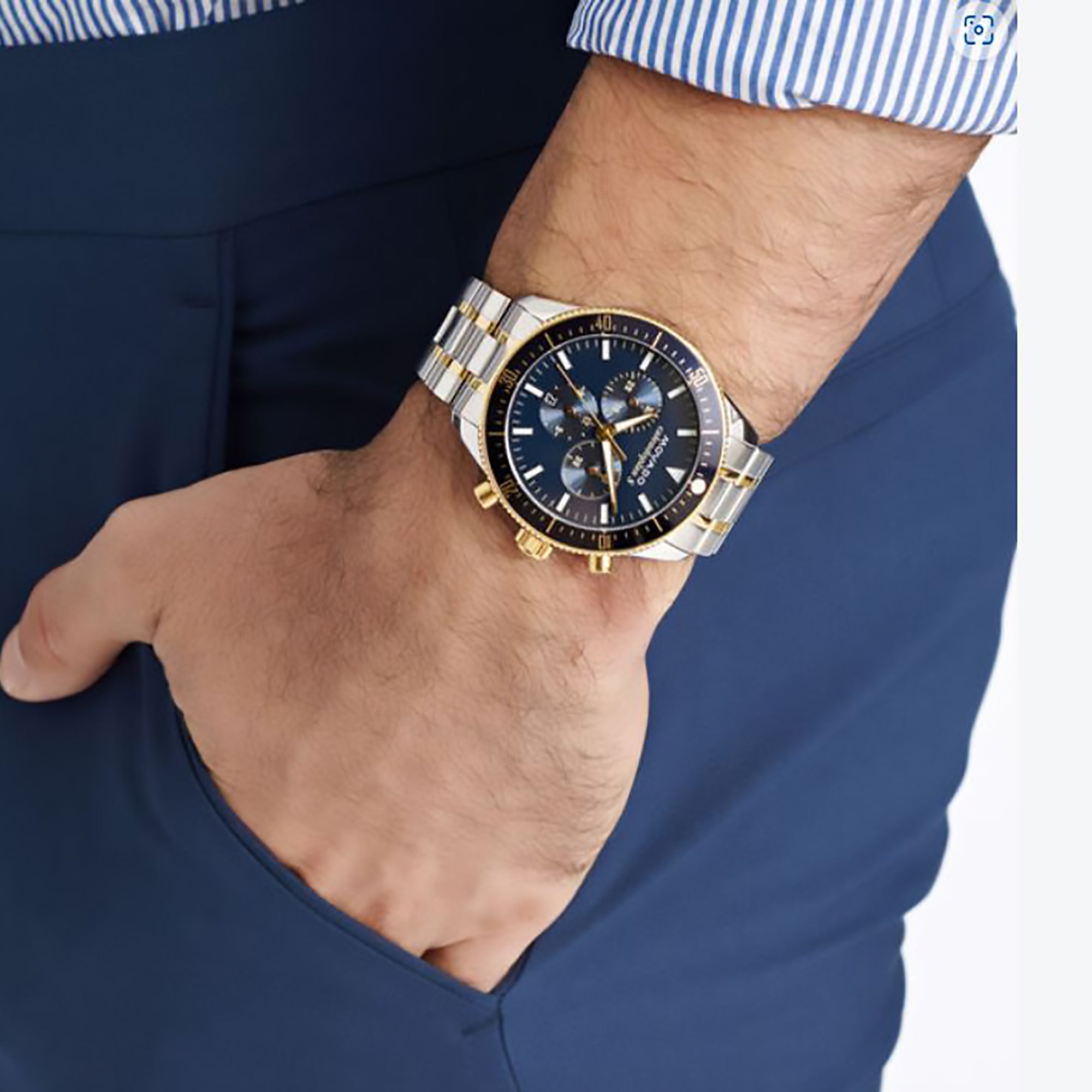 Movado Heritage Calendoplan S chronograph watch worn on wrist with blue dial and two-tone bracelet