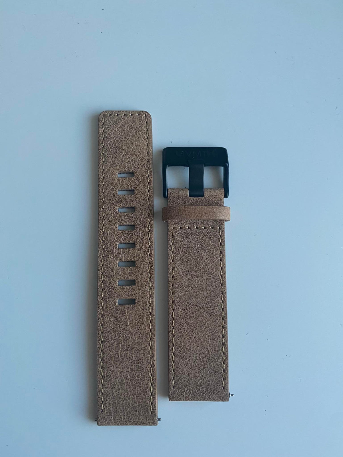 MVMT leather watch strap with navy hardware buckle on light background