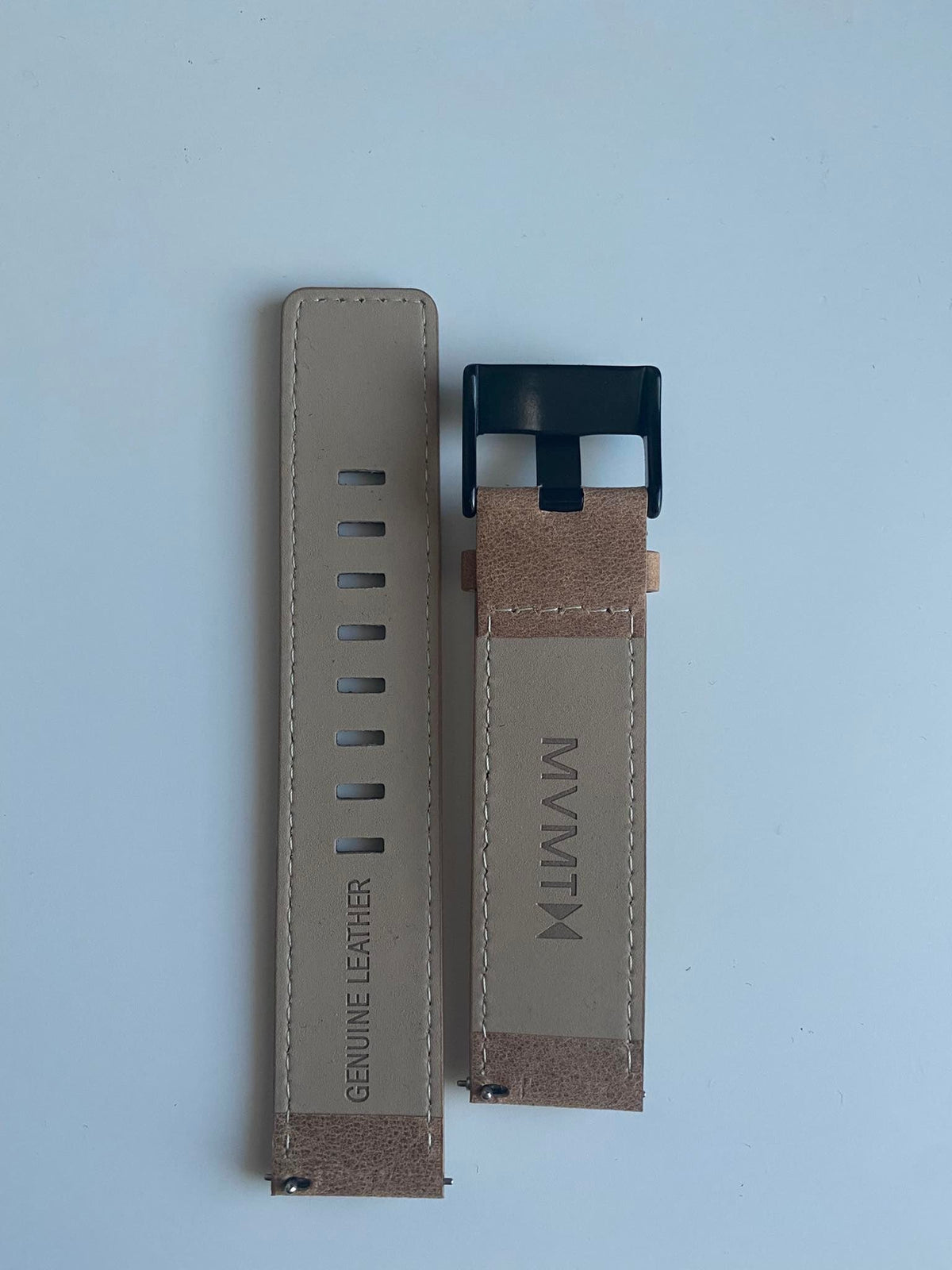 MVMT genuine leather strap showing adjustment holes and navy quick-release buckle