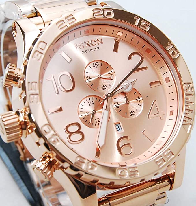 Close-up of Nixon 42-20 dial showing rose finish with hour markers, chronograph subdials, and date