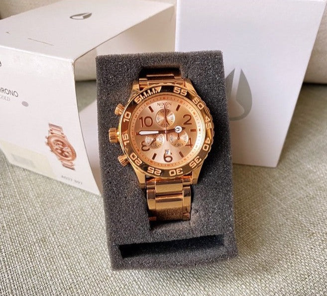 Nixon 42-20 watch displayed in retail packaging box with gray foam insert